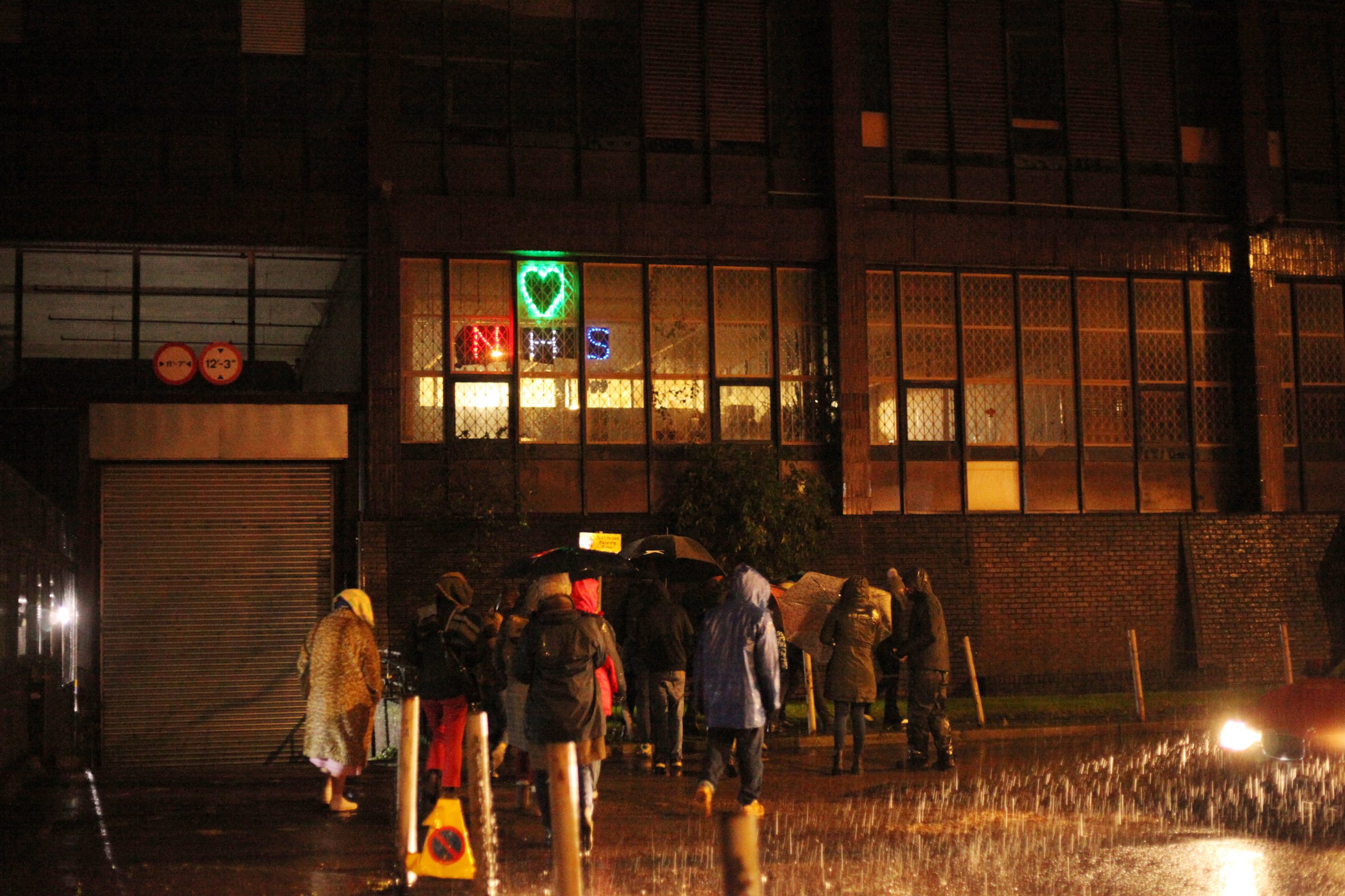 people walking on a city street in the heavy rain
